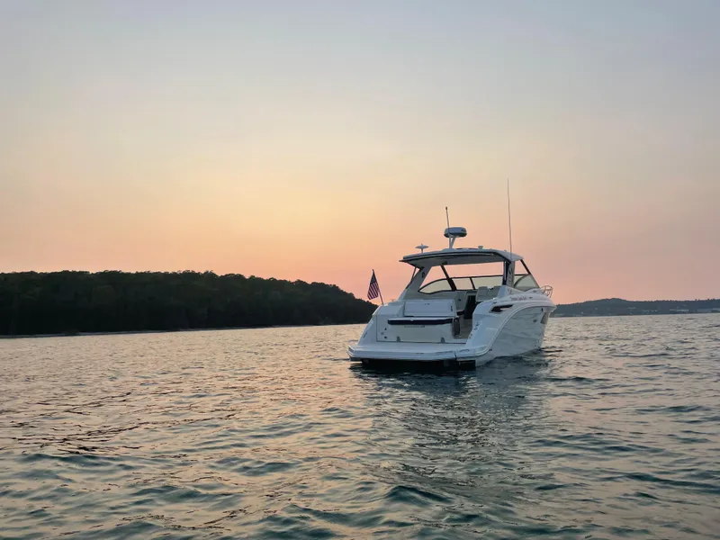 Slide: The Image of A 2020 Sea Ray Sundancer 320 on calm waters at sunset. - 6