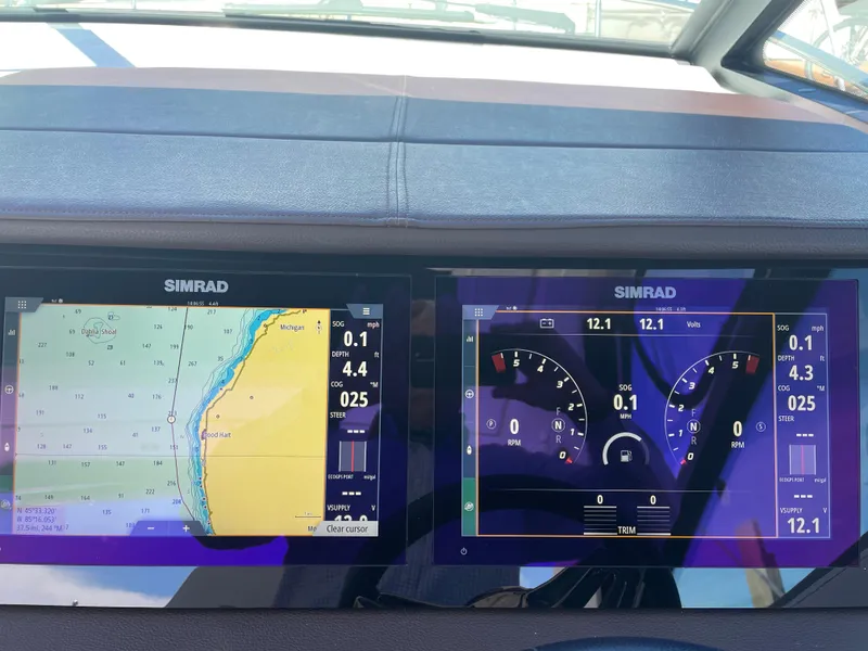 Slide: The Image of The image shows two Simrad screens on a boat. The left screen displays a nautical chart, the right screen shows navigation data. - 13