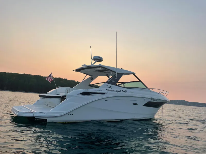 Slide: The Image of A 2020 Sea Ray Sundancer 320 on calm water at sunset. - 4