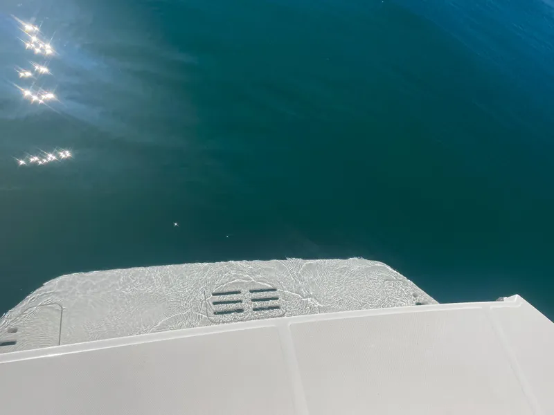 Slide: The Image of The image shows the stern of a boat on calm water. - 34
