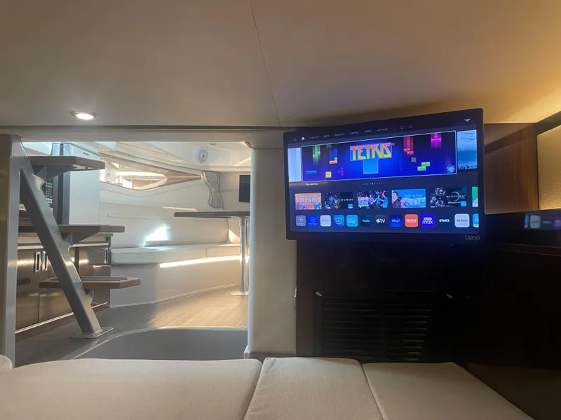 Slide: The Image of Interior of a Sea Ray Sundancer 320 with a TV and modern furnishings. - 32