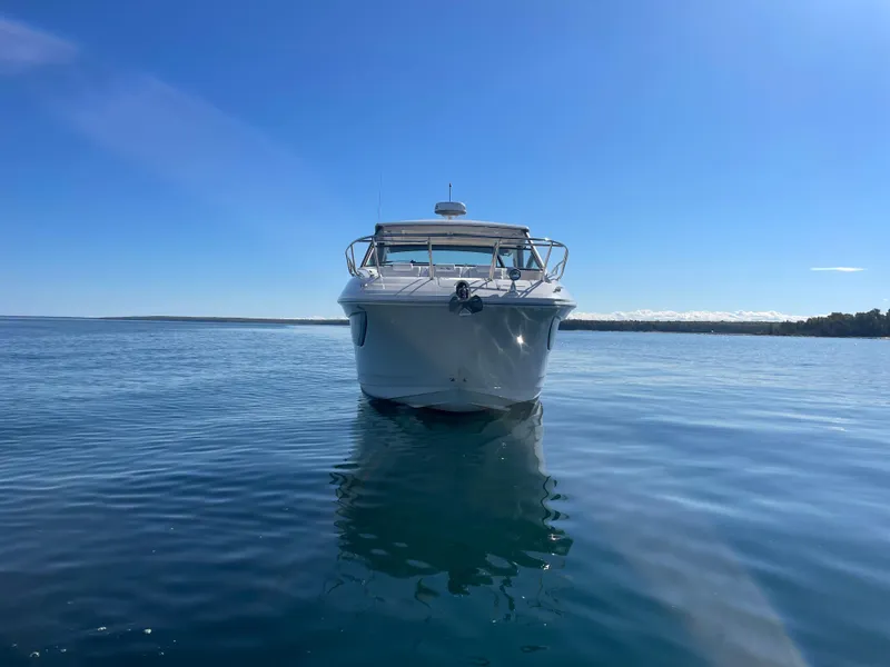Slide: The Image of The 2020 Sea Ray Sundancer 320 cruising on calm waters under a clear sky. - 2