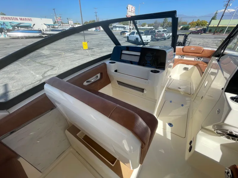 Slide: The Image of 2024 Scout 277 Dorado boat interior with brown and white seating. - 10