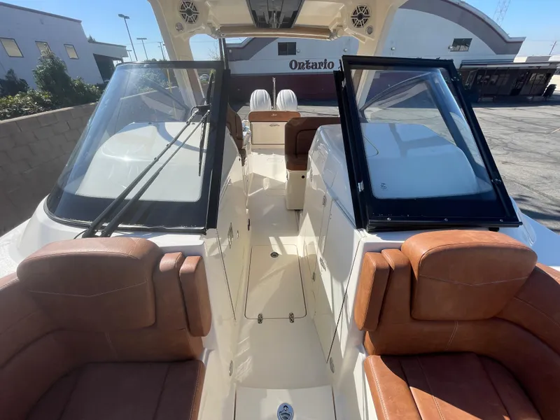 Slide: The Image of 2024 Scout 277 Dorado boat with luxurious seating and dual windshields. - 12