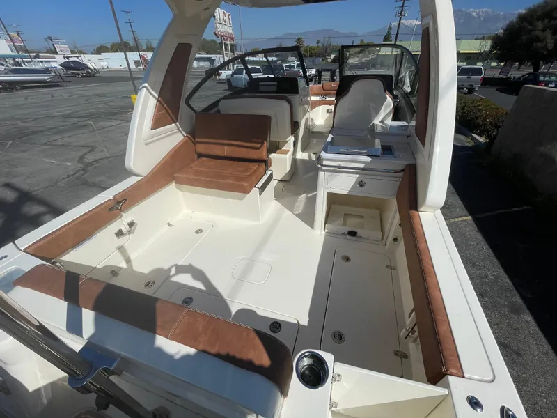 Slide: The Image of 2024 Scout 277 Dorado boat interior with brown seating and white deck. - 4