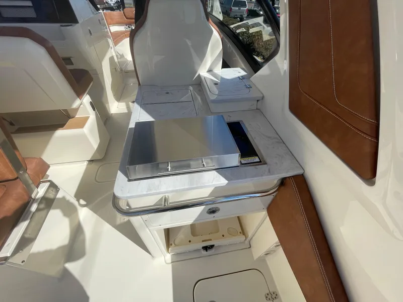 Slide: The Image of 2024 Scout 277 Dorado boat interior with seating and storage compartments. - 5
