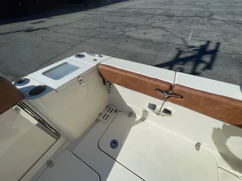 Slide: The Image of 2024 Scout 277 Dorado boat interior with tan seating and storage compartments. - 8