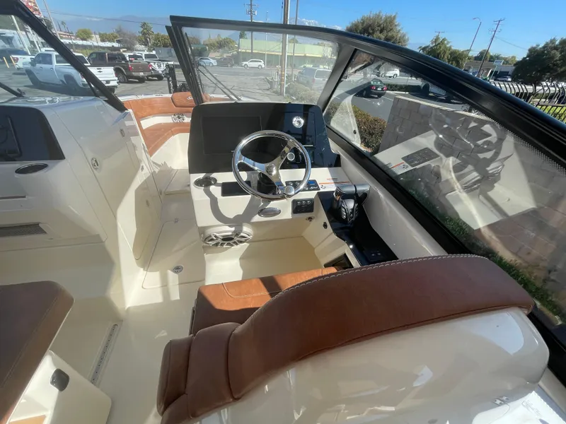 Slide: The Image of 2024 Scout 277 Dorado boat interior with steering wheel and seating. - 9