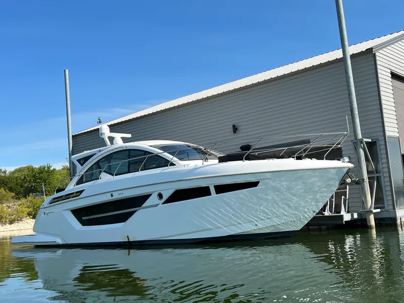 Slide: The Image of 2018 Cruisers Yachts 50 Cantius docked by a modern marina. - 1