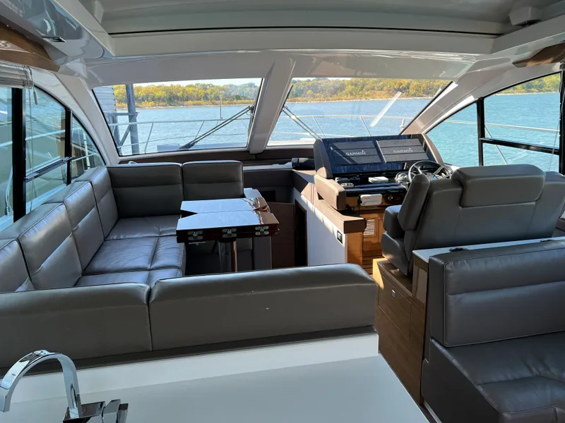 Slide: The Image of Interior of 2018 Cruisers Yachts 50 Cantius with leather seating and helm station. - 15