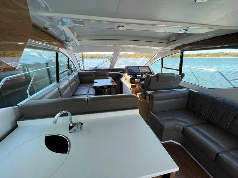 Slide: The Image of Interior of 2018 Cruisers Yachts 50 Cantius with modern seating and panoramic windows. - 18