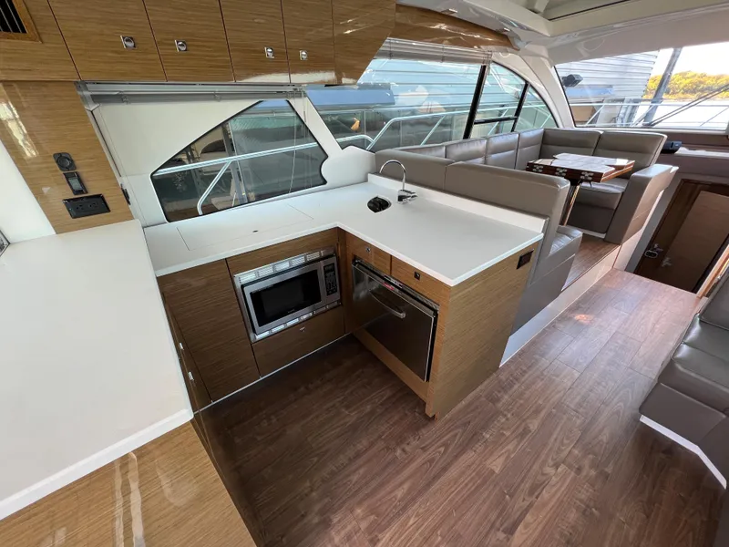 Slide: The Image of Modern kitchen and seating area inside 2018 Cruisers Yachts 50 Cantius. - 23