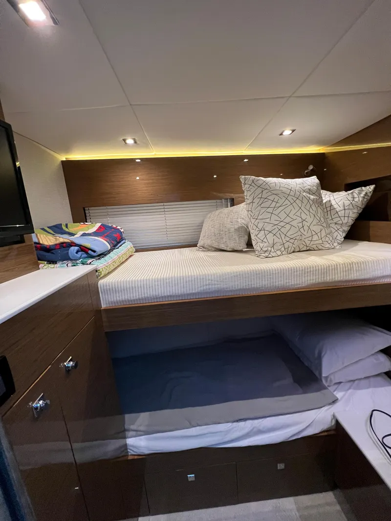 Slide: The Image of 2018 Cruisers Yachts 50 Cantius interior cabin with bunk beds and modern lighting. - 29
