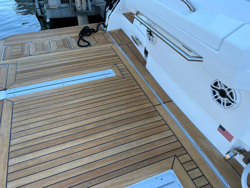 Slide: The Image of Teak deck of a 2018 Cruisers Yachts 50 Cantius at a marina. - 34