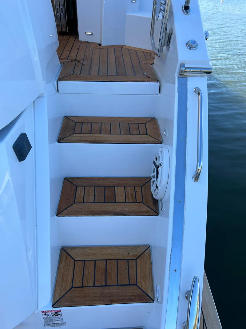 Slide: The Image of Staircase on 2018 Cruisers Yachts 50 Cantius with teak steps and stainless steel handrails. - 35