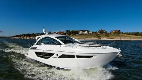 Slide: The Image of 2018 Cruisers Yachts 50 Cantius cruising on open water near the shore. - 5