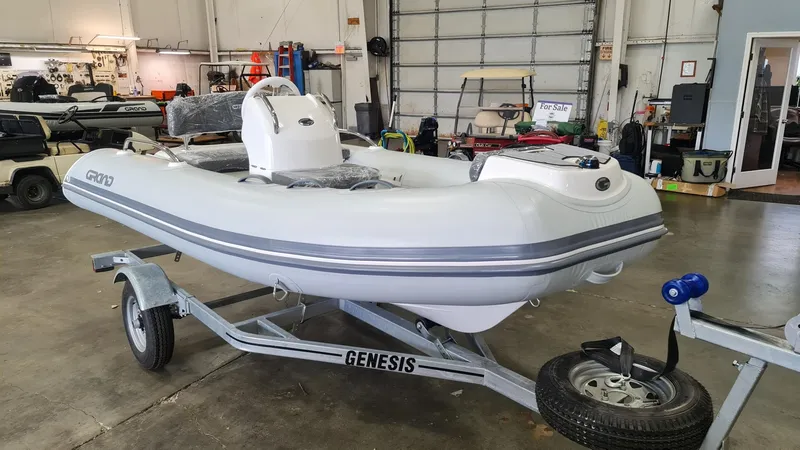 Slide: The Image of 2023 Grand Inflatables G380HLF boat on Genesis trailer in a garage. - 3