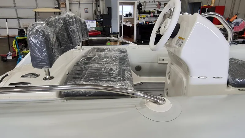 Slide: The Image of 2023 Grand Inflatables G380HLF boat interior with steering console and seating. - 6