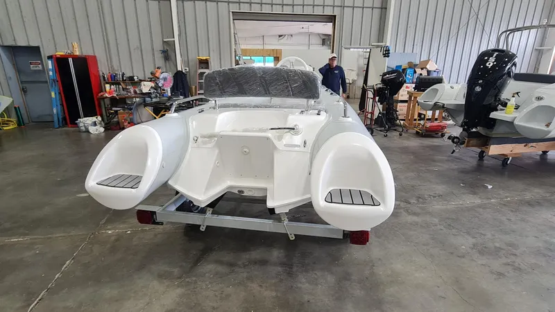 Slide: The Image of 2023 Grand Inflatables G380HLF boat in a workshop, rear view. - 8