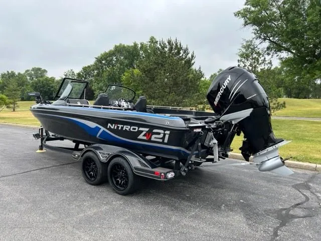 Slide: The Image of 2023 Nitro ZV21 Pro fishing boat with Mercury outboard motor on a trailer. - 2