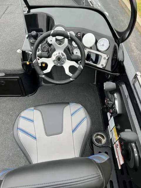 Slide: The Image of 2023 Nitro ZV21 Pro boat cockpit with steering wheel and captain's seat. - 4