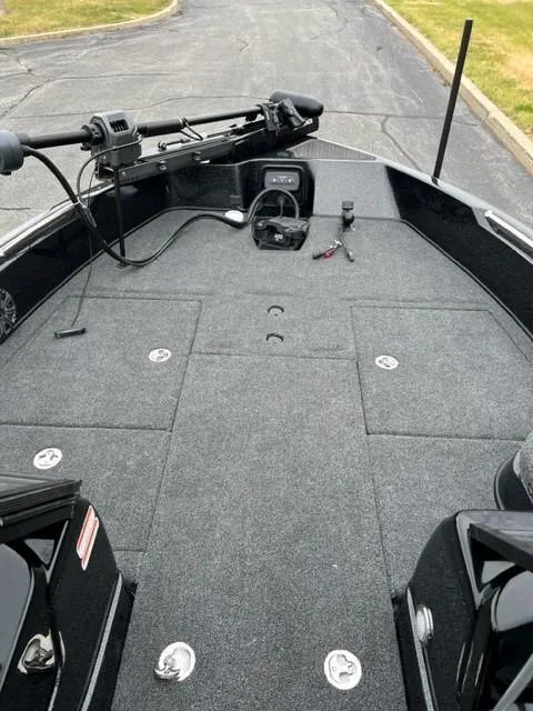 Slide: The Image of 2023 Nitro ZV21 Pro fishing boat deck with trolling motor and storage compartments. - 5
