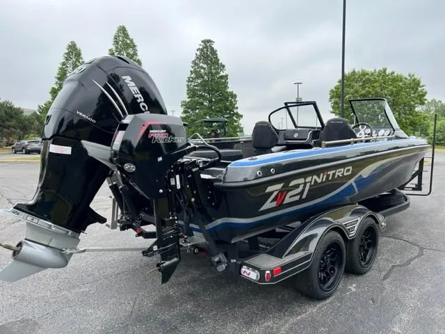 Slide: The Image of 2023 Nitro ZV21 Pro boat with Mercury outboard motor in a parking lot. - 8