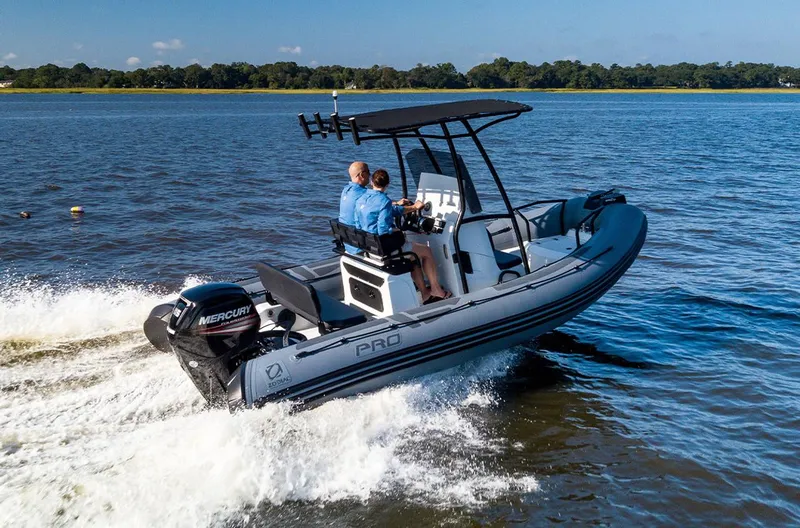 The Image of 2023 Zodiac Pro 5.5 boat cruising on a lake with two passengers. - 1
