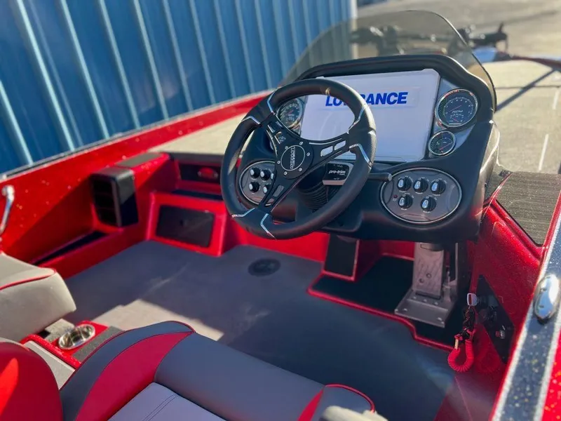 Slide: The Image of 2023 Triton 21 TrX Patriot boat cockpit with steering wheel and control panel. - 4