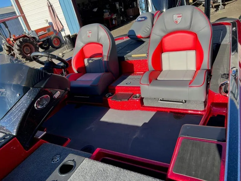 Slide: The Image of 2023 Triton 21 TrX Patriot boat interior with red and gray seats. - 7