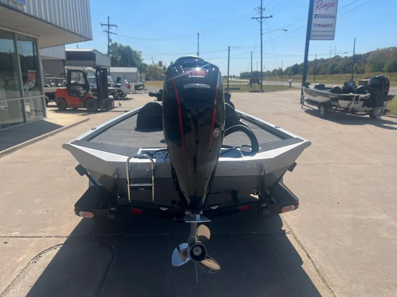 Slide: The Image of 2023 Vexus AVX 189c boat with outboard motor, rear view in a dealership lot. - 3