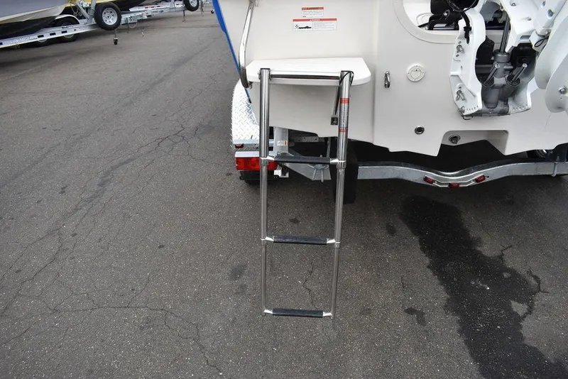 Slide: The Image of 2022 Carolina Skiff 19 Ultra Elite boat with rear ladder on trailer. - 10