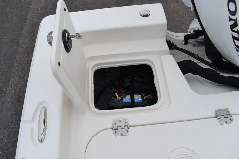 Slide: The Image of 2022 Carolina Skiff 19 Ultra Elite boat battery compartment with open hatch. - 15