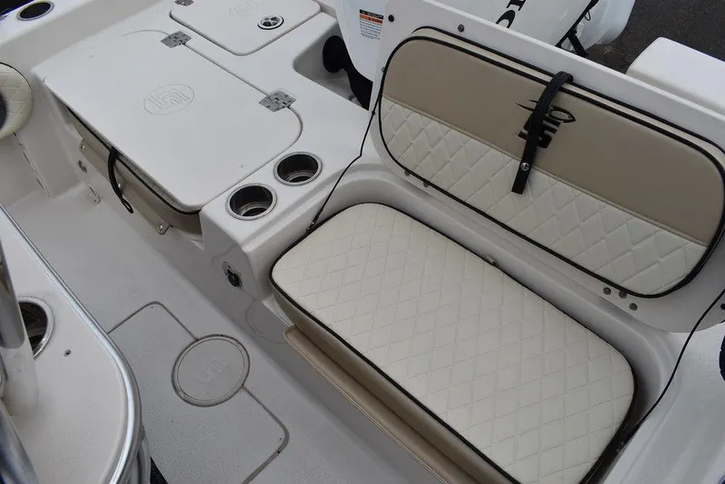 Slide: The Image of 2022 Carolina Skiff 19 Ultra Elite boat interior with cushioned seating and storage compartments. - 17