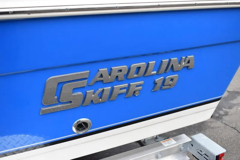 Slide: The Image of 2022 Carolina Skiff 19 Ultra Elite boat with blue and white exterior. - 34