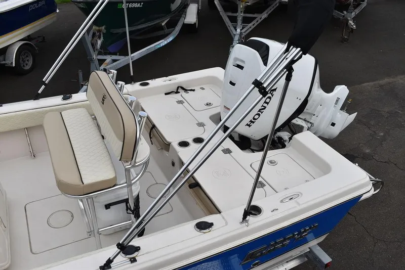 Slide: The Image of 2022 Carolina Skiff 19 Ultra Elite boat with Honda motor, beige seating, and blue exterior. - 4