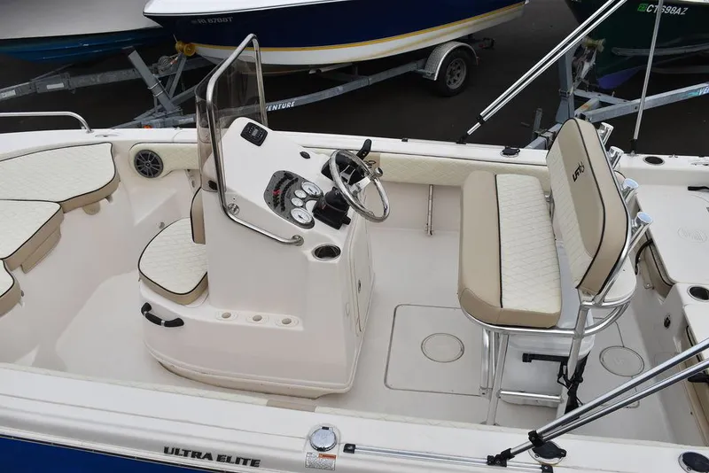 Slide: The Image of 2022 Carolina Skiff 19 Ultra Elite boat interior with seating and steering console. - 5