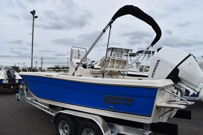 Slide: The Image of 2022 Carolina Skiff 19 Ultra Elite boat with Honda outboard motor on trailer. - 9