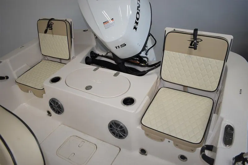 Slide: The Image of 2023 Carolina Skiff 19 LS boat interior with Honda engine and cushioned seating. - 11