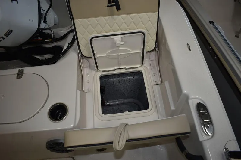 Slide: The Image of 2023 Carolina Skiff 19 LS boat interior storage compartment with open hatch. - 12