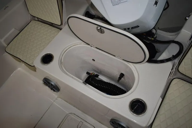 Slide: The Image of 2023 Carolina Skiff 19 LS boat interior with open storage compartment and seating. - 13