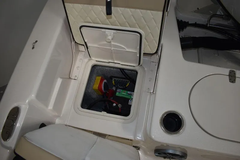 Slide: The Image of 2023 Carolina Skiff 19 LS boat storage compartment with battery and wiring. - 14