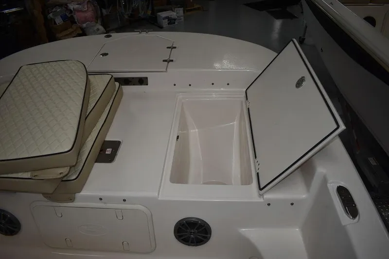 Slide: The Image of 2023 Carolina Skiff 19 LS boat interior with open storage compartment and cushioned seating. - 19