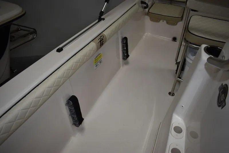 Slide: The Image of 2023 Carolina Skiff 19 LS interior with cushioned seating and storage compartments. - 21