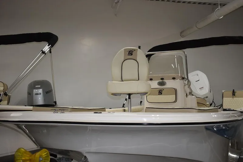 Slide: The Image of 2023 Carolina Skiff 19 LS boat in showroom, featuring seating and console. - 22