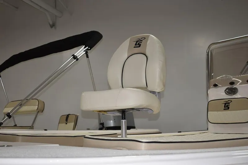 Slide: The Image of 2023 Carolina Skiff 19 LS boat interior with beige seating and console. - 23