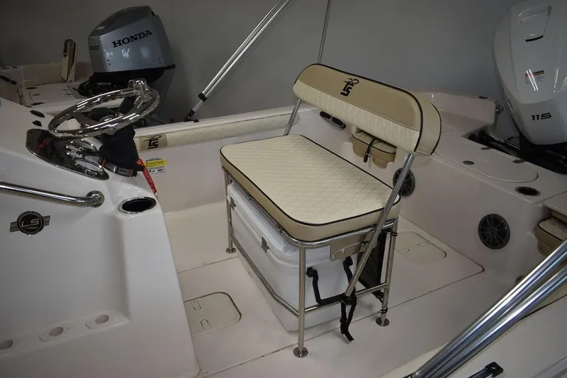 Slide: The Image of 2023 Carolina Skiff 19 LS boat interior with seating and Honda outboard motor. - 4