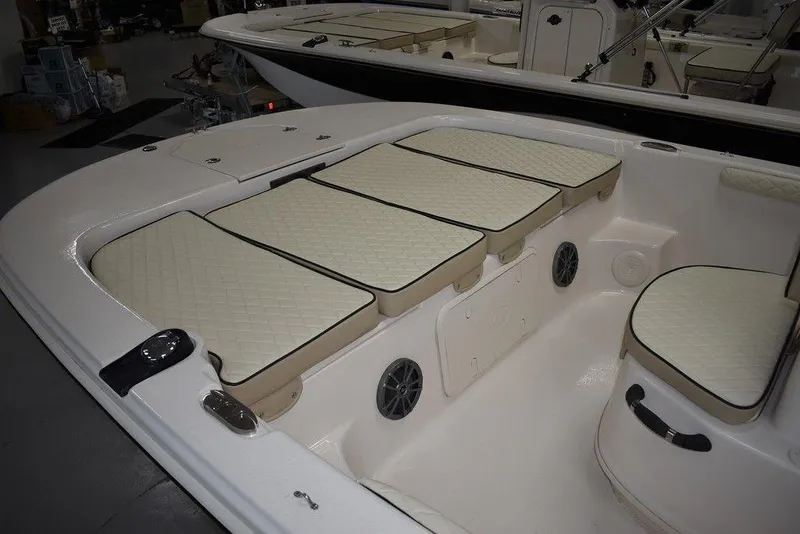 Slide: The Image of 2023 Carolina Skiff 19 LS boat interior with cushioned seating and storage compartments. - 5