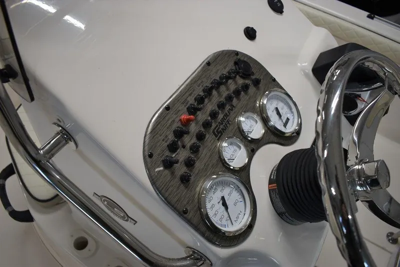 Slide: The Image of 2023 Carolina Skiff 19 LS dashboard with gauges and steering wheel. - 8