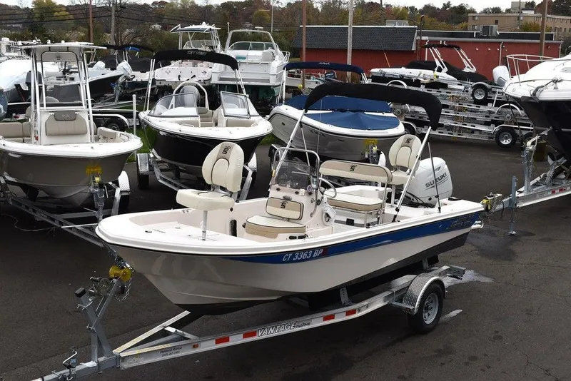Slide: The Image of 2023 Carolina Skiff 178 JLS boat on a trailer in a marina. - 0